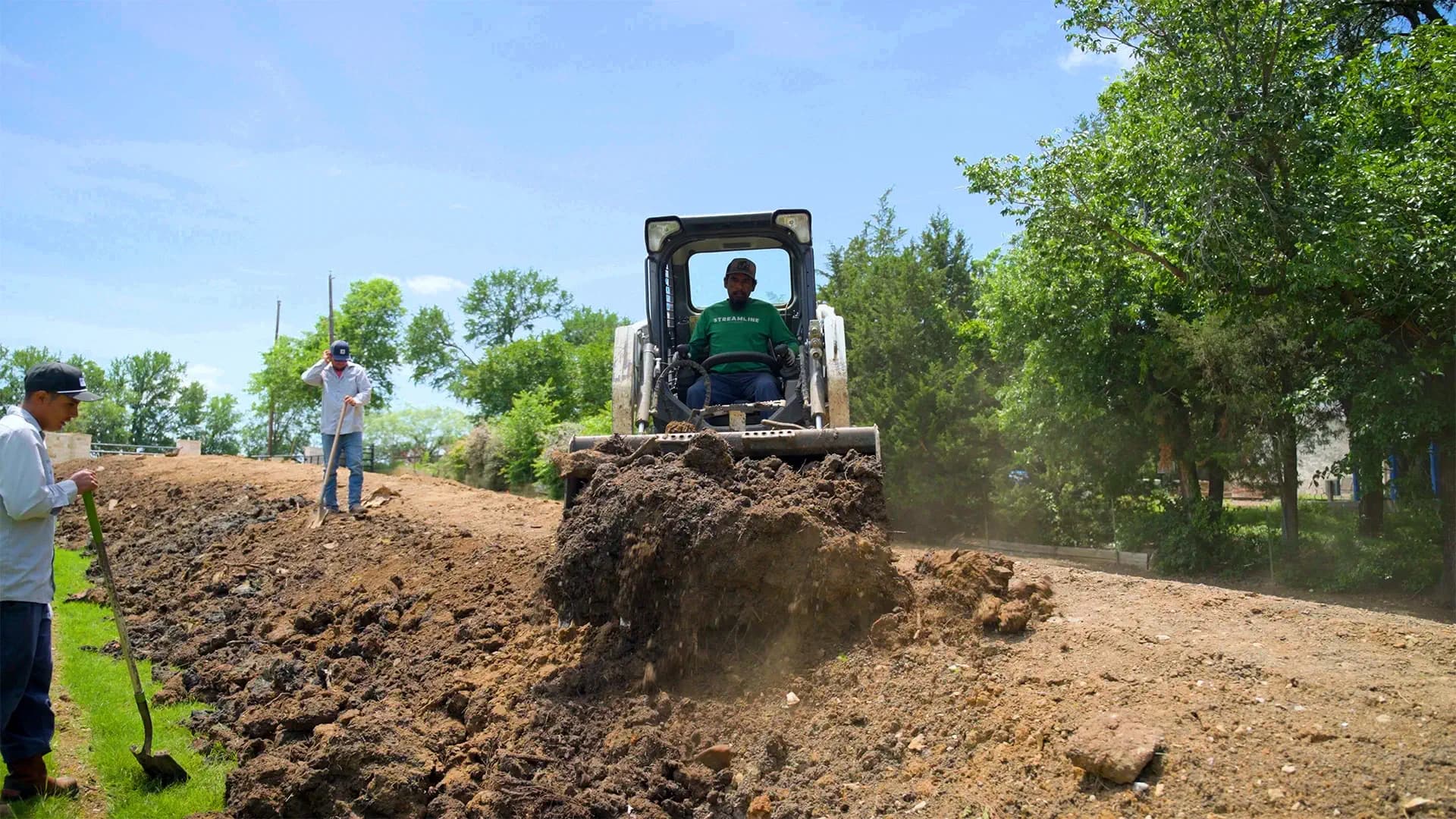A Streamline crew member operating a track loader while spreading fill dirt